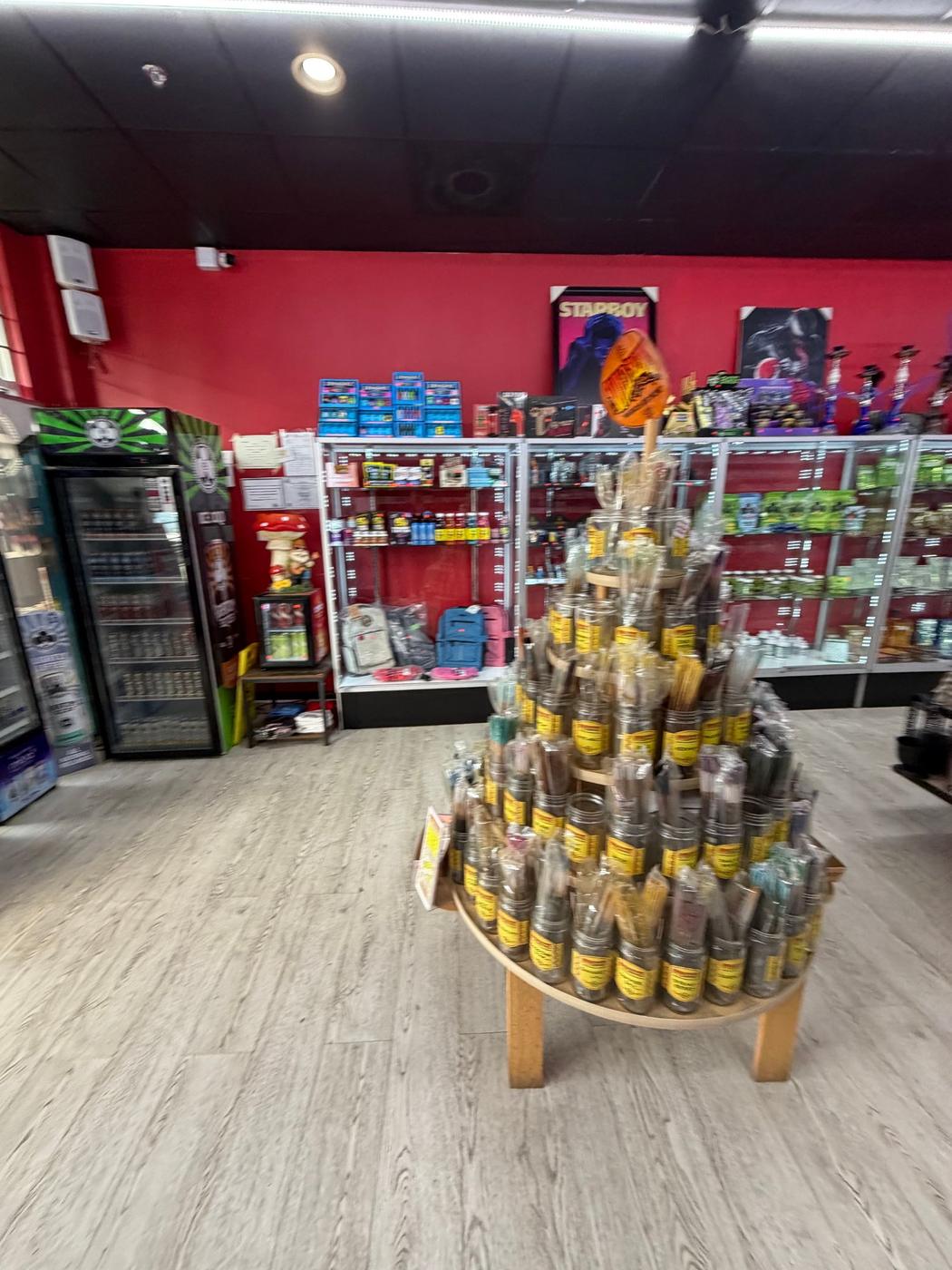 The incense tower on the floor and the accessory shelf behind it.